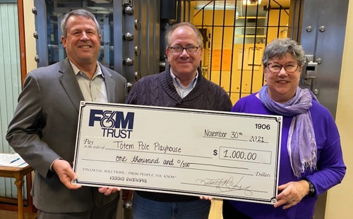 Martha Walker, Tim Henry and David Hemsley pictured with large presentation check