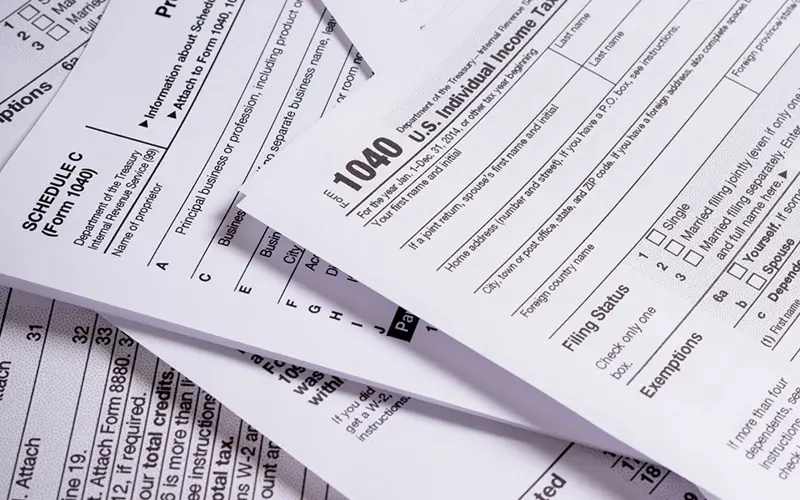 various tax forms in a pile