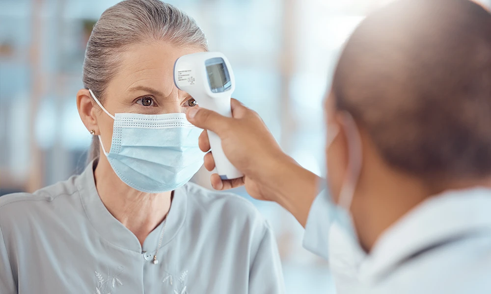 woman getting her temperature taken
