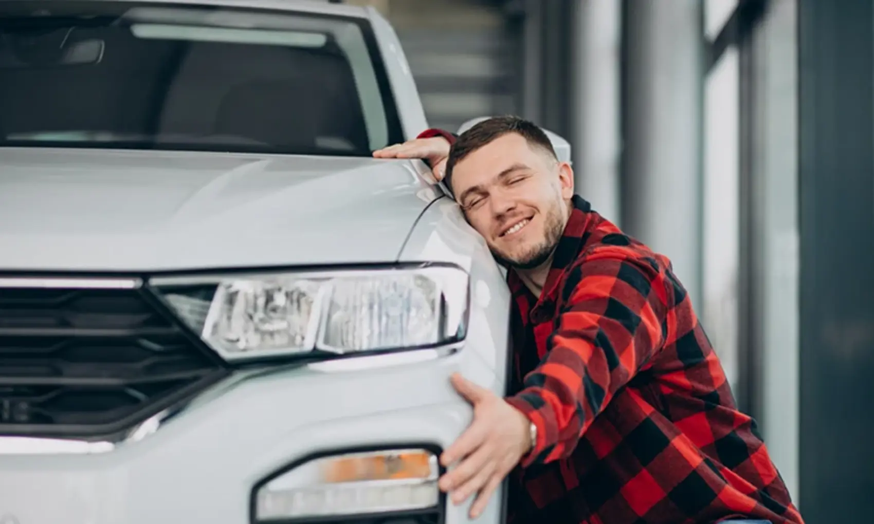 Man hugging car