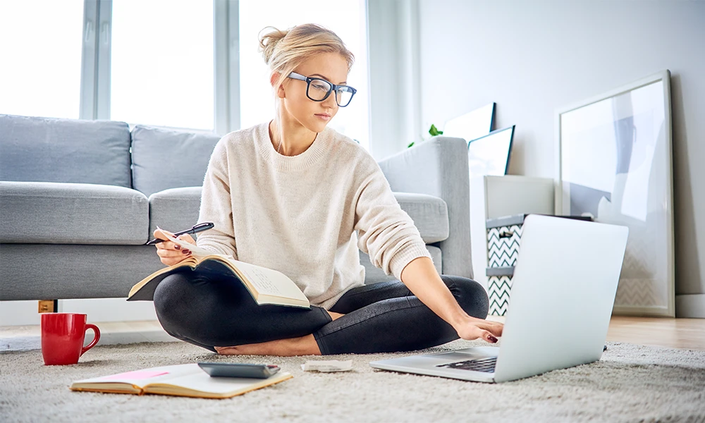 young woman at home balancing her budget