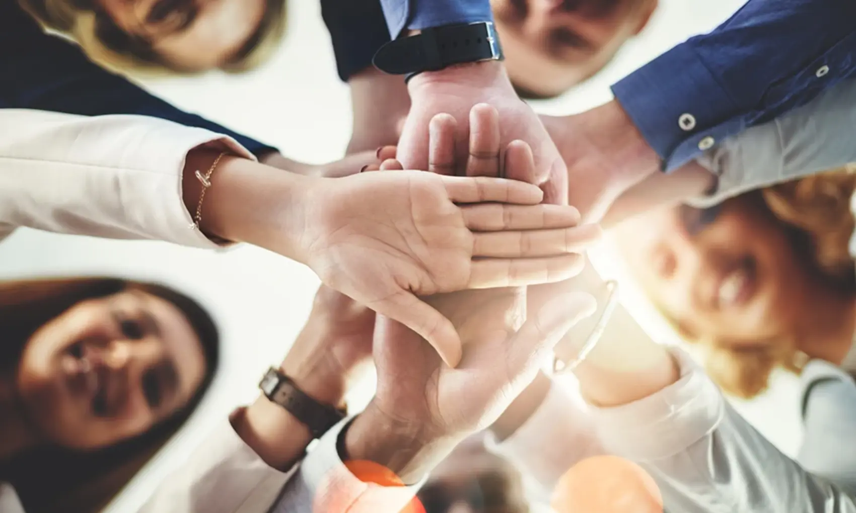 Team members all hands in