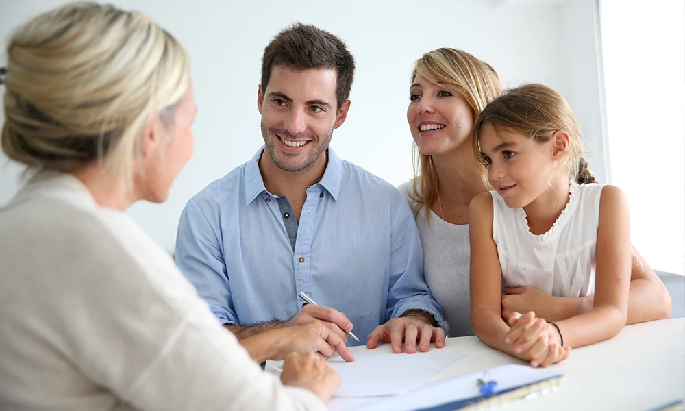 parents with a young daughter speak with an advisor