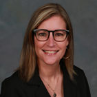 Professional headshot of Chastity Wantz wearing glasses, a black blazer, and a necklace.