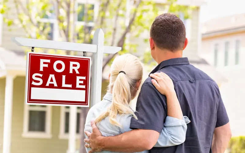 Man and woman admiring recent purchased home