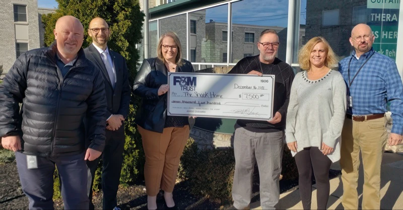 FMT and The Shook Home representatives with large donation check