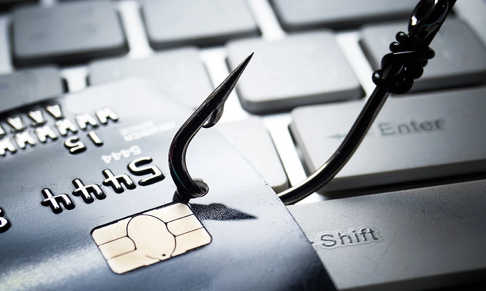 fishing hook catches a credit card