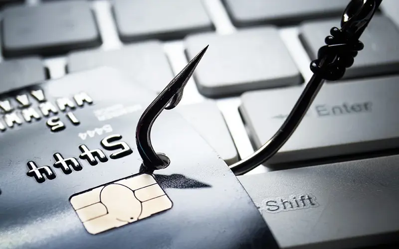 fishing hook catches a credit card