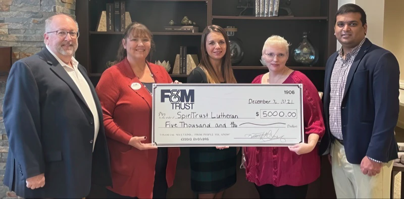 FMT and SpiriTrust Lutheran representatives with large donation check