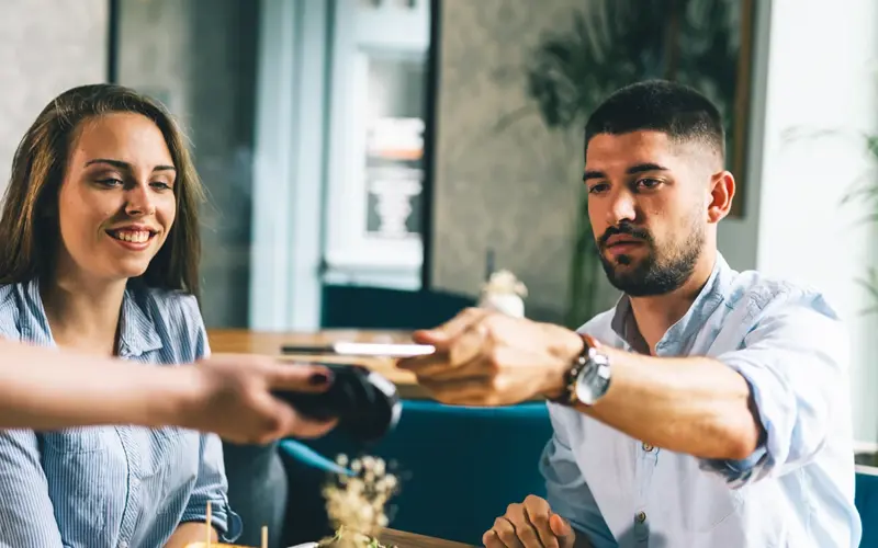 Man paying for a meal with his phone