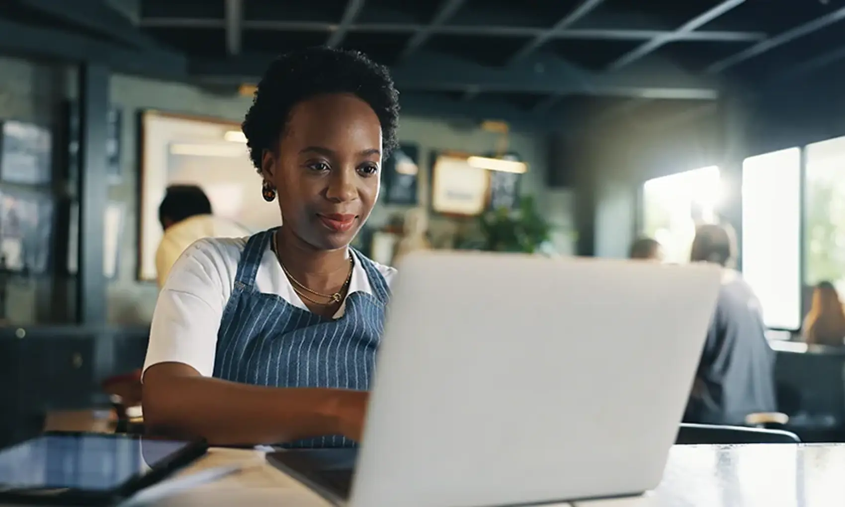 Typing, laptop and planning with woman in cafe