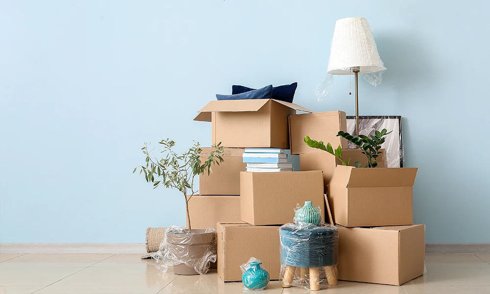 pile of moving boxes and other stuff in shrinkwrap