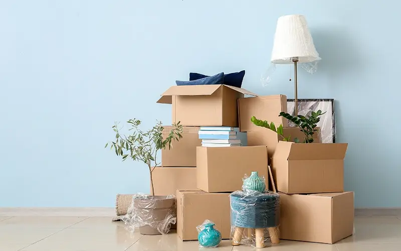 pile of moving boxes and other stuff in shrinkwrap