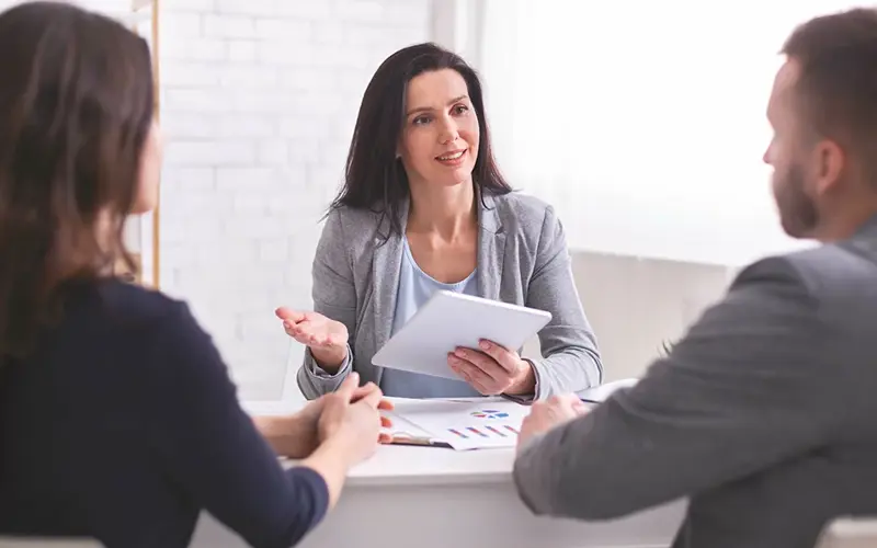 financial planner speaking with a couple