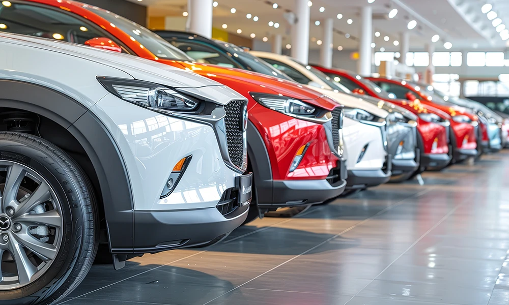 a line of new cars at a dealer