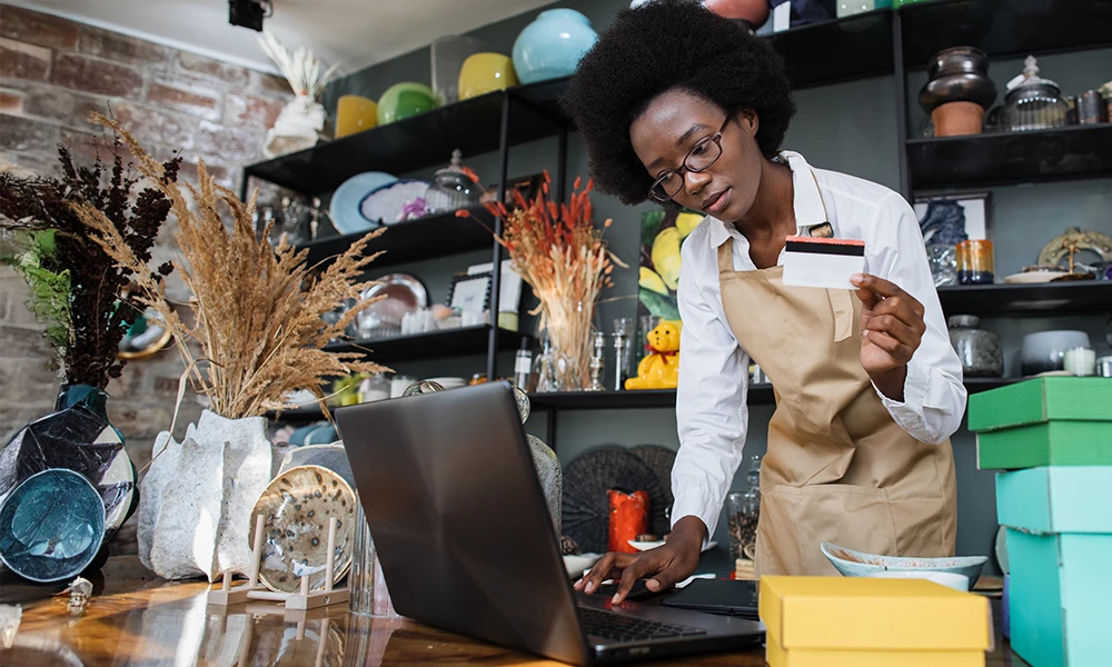 store clerk using credit card to buy merchandise