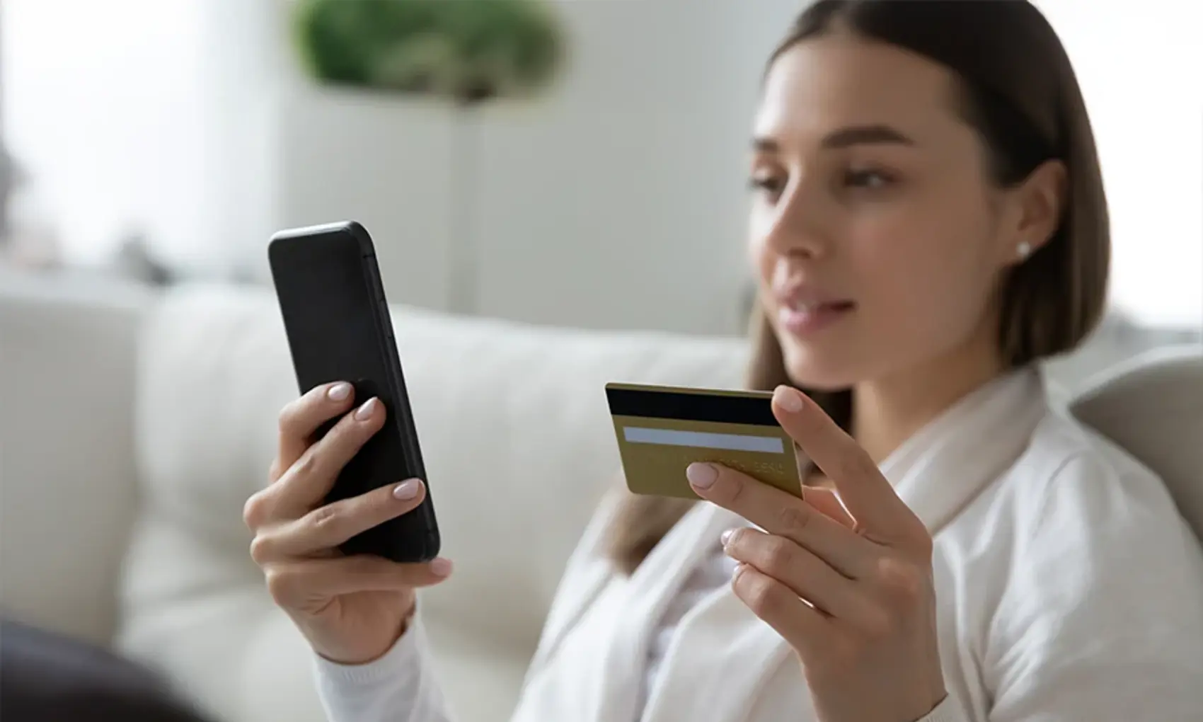 woman using credit card on smartphone