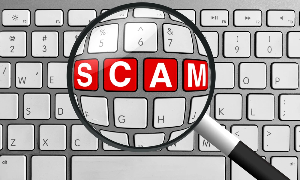 the word scam under a magnify glass