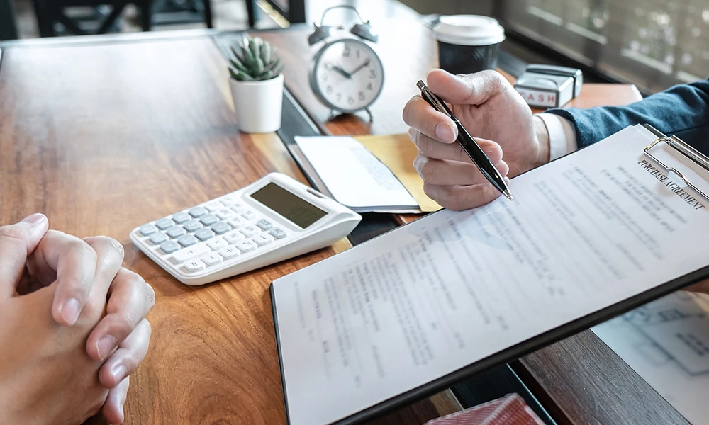 person explaining purchase agreement paperwork
