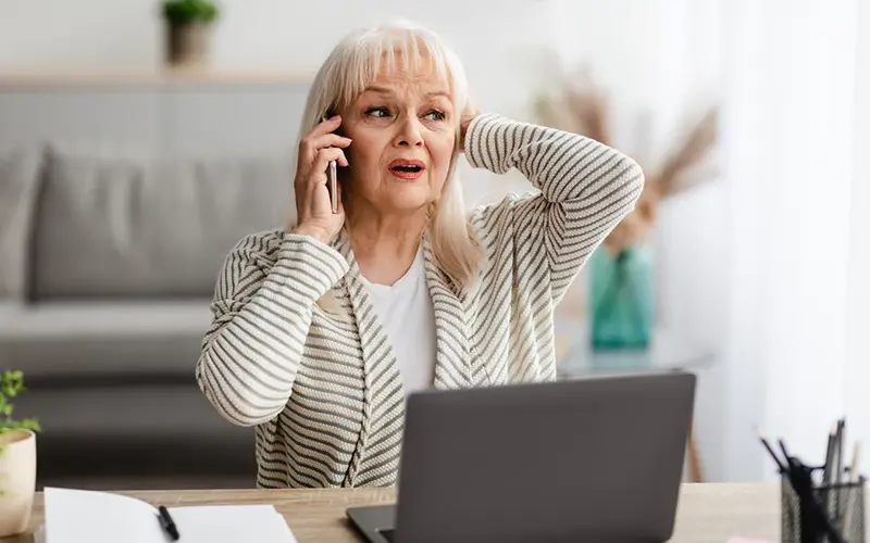 Concerned older woman on the phone