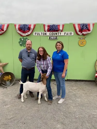 bank reps standing with Molly and her goat