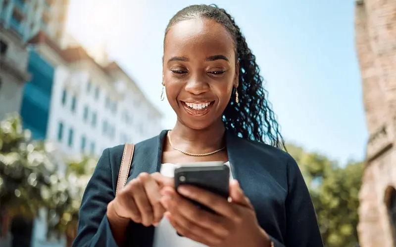 Smiling woman using her cell phone