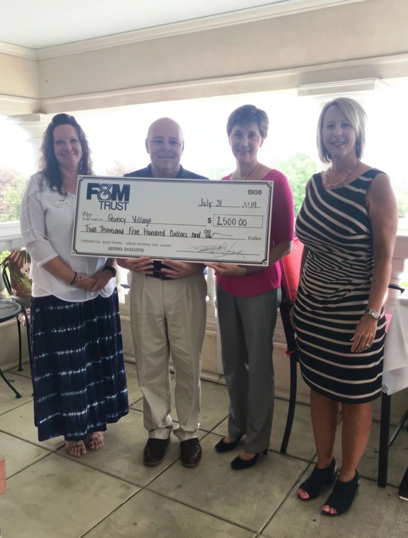 people posing for check presentation