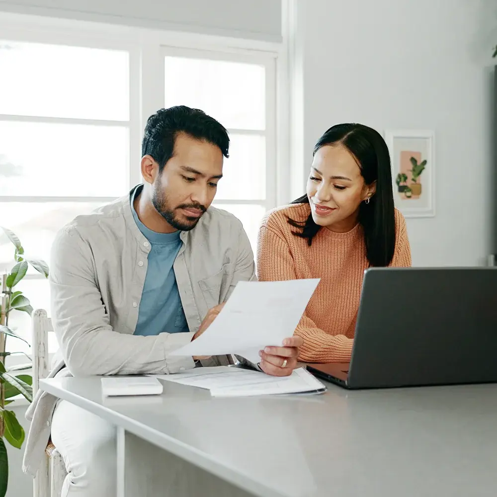 Kitchen, couple and conversation with document for finance, track expenses and laptop for budget goal