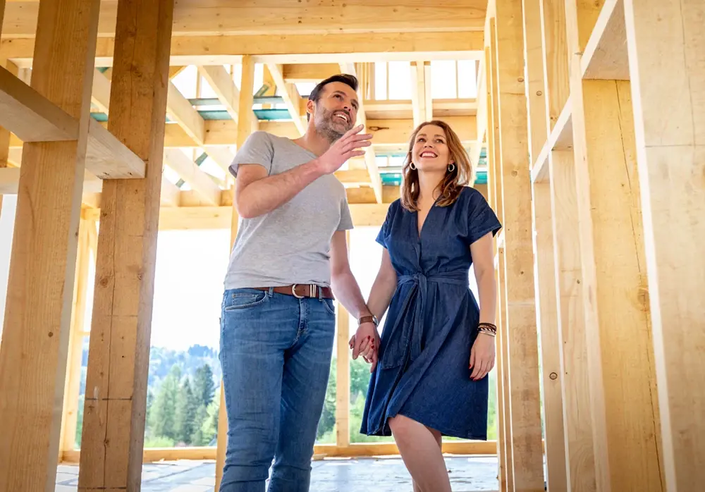 Man and woman touring construction of new home