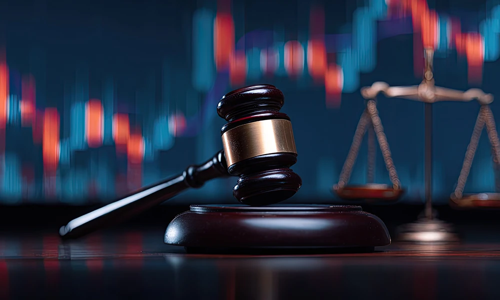 gavel and justice scale in front of chart of stocks rising and dropping 