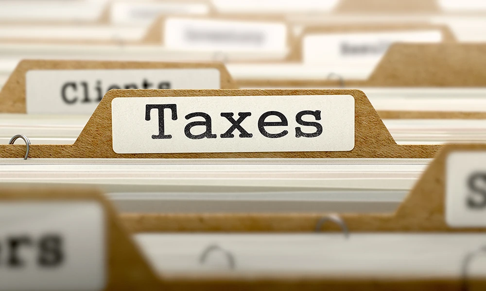 tab of a folder in a file cabinet that reads Taxes