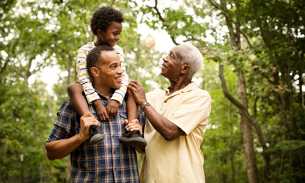 three generations of males together in a park