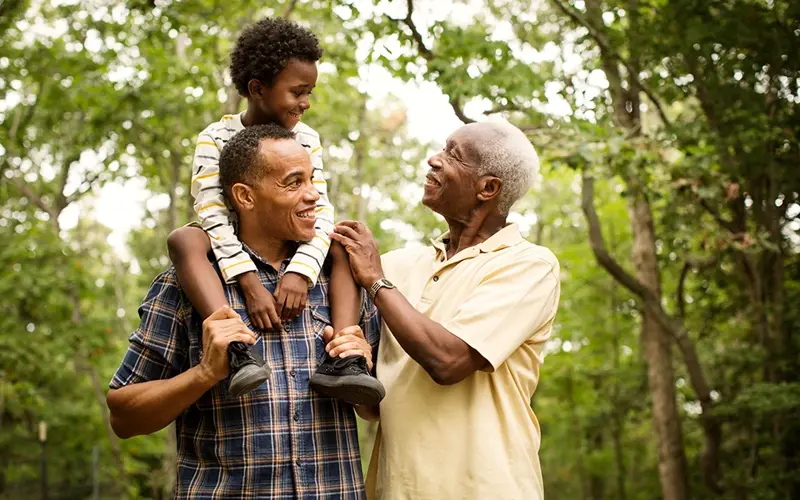 three generations of males together in a park
