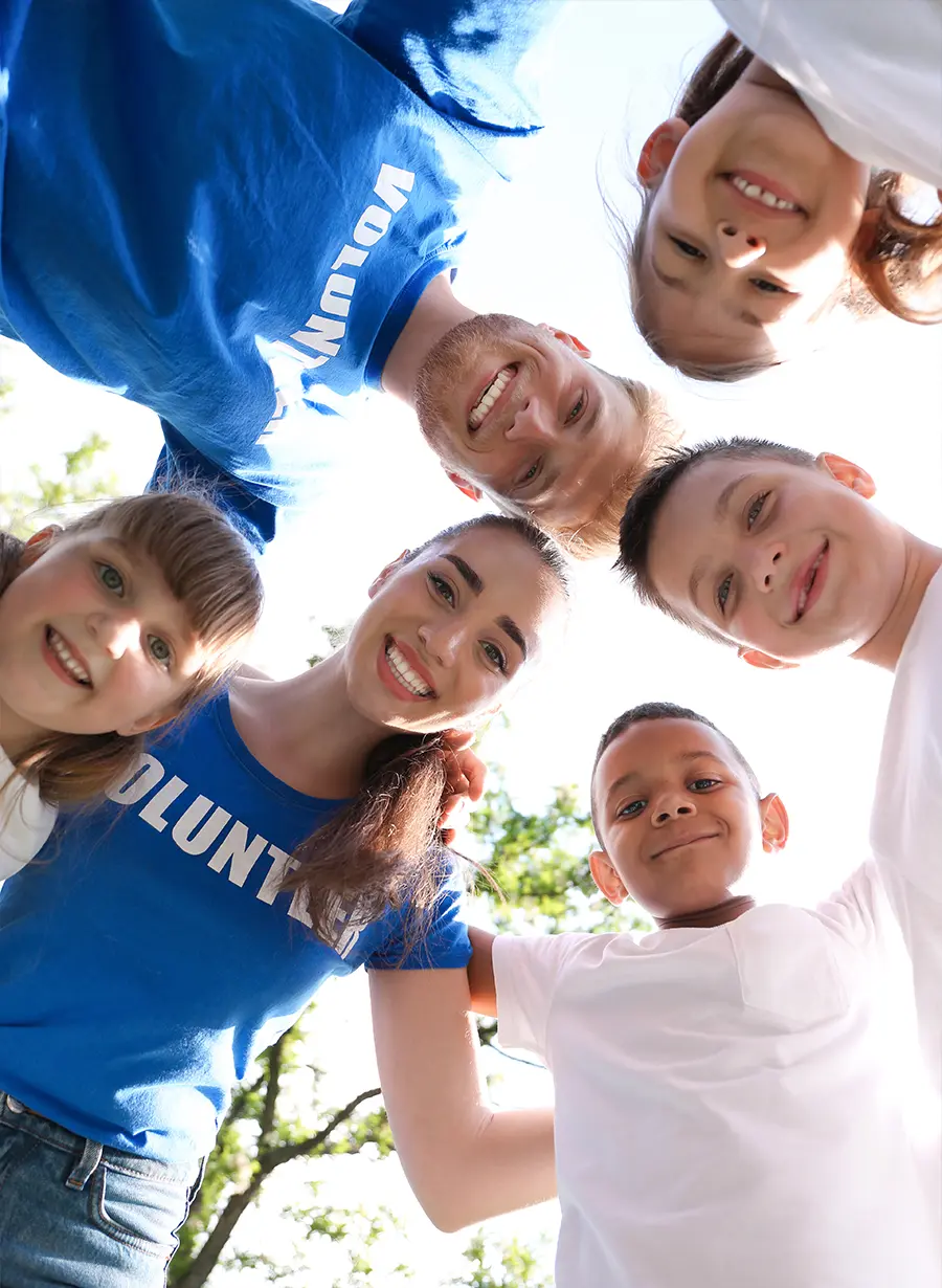 Volunteers smiling in a huddled group